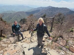 In many ways it was a resounding hike. Thirteen hours from the car park and back. Jirisan is a steep course. The ascent to Cheonwangbong (1915m) is 1300m in only 5km. It was a good reminder for my two American guests. I always find it hard to determine the exact time it will take to do the loop course. 8-12hrs. 
It was a pearler of a day. The weather was stunning. Spring greens and heaven blue sky. A cool zephyr. At the summit area it was much windier and cooler. A hoar frost and sleet 상고대 stuck to the trees and inside rocks. 
The only thing open by the time we get back to the dark and still carpark was the GS25. It had an excellent hall out the back with tables and chairs, and a couple of posse&rsquo;s of misfit late night hikers. Hot water area for cooking noodles which is what we did with a beer. Fantastic achievement for them two. Strong memories of Korea from this. They never shirked for a moment. Chur.